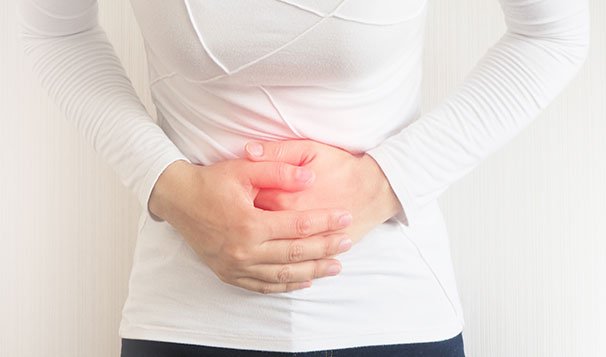 man holding his aching stomach